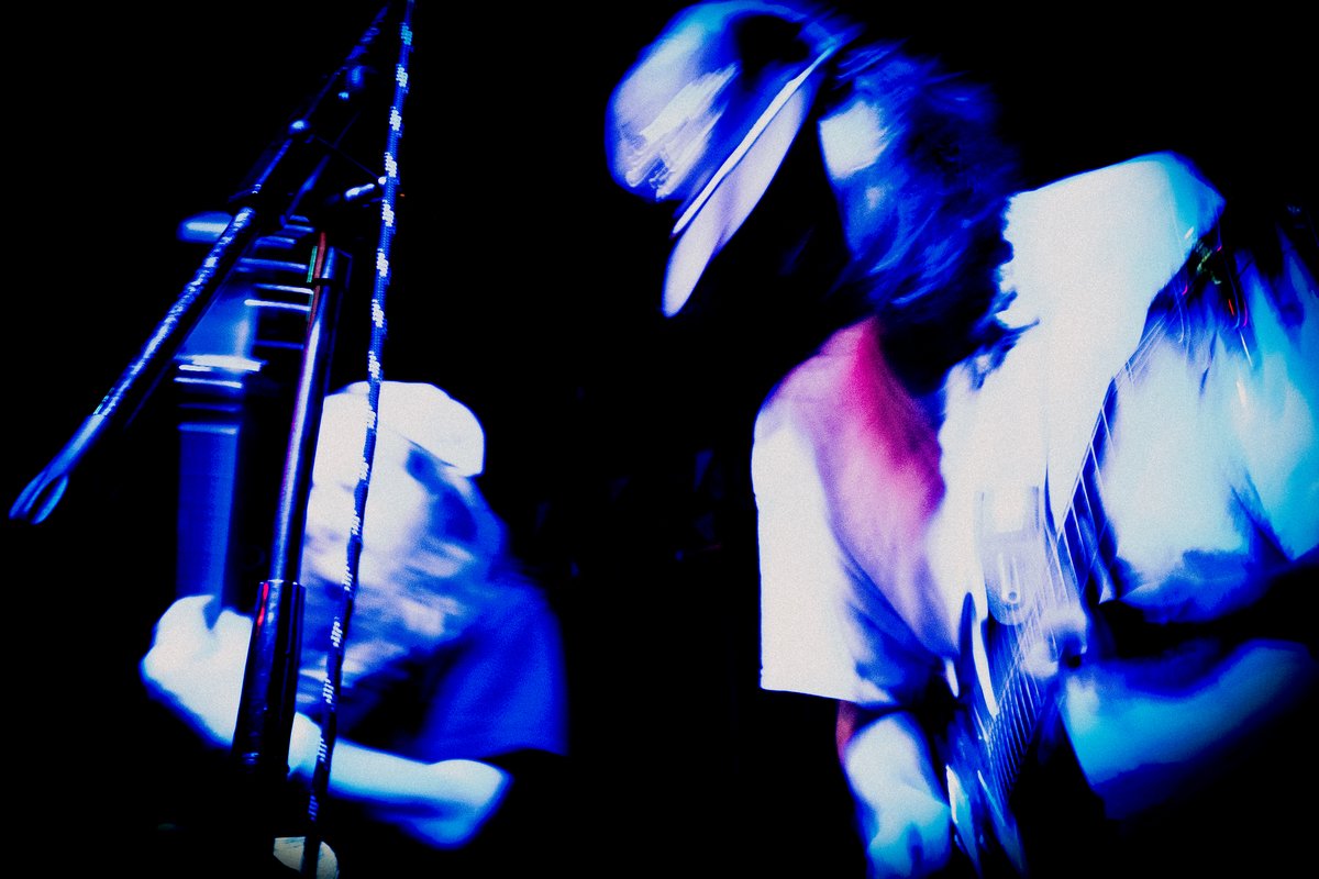 The Wingos on stage under blue light